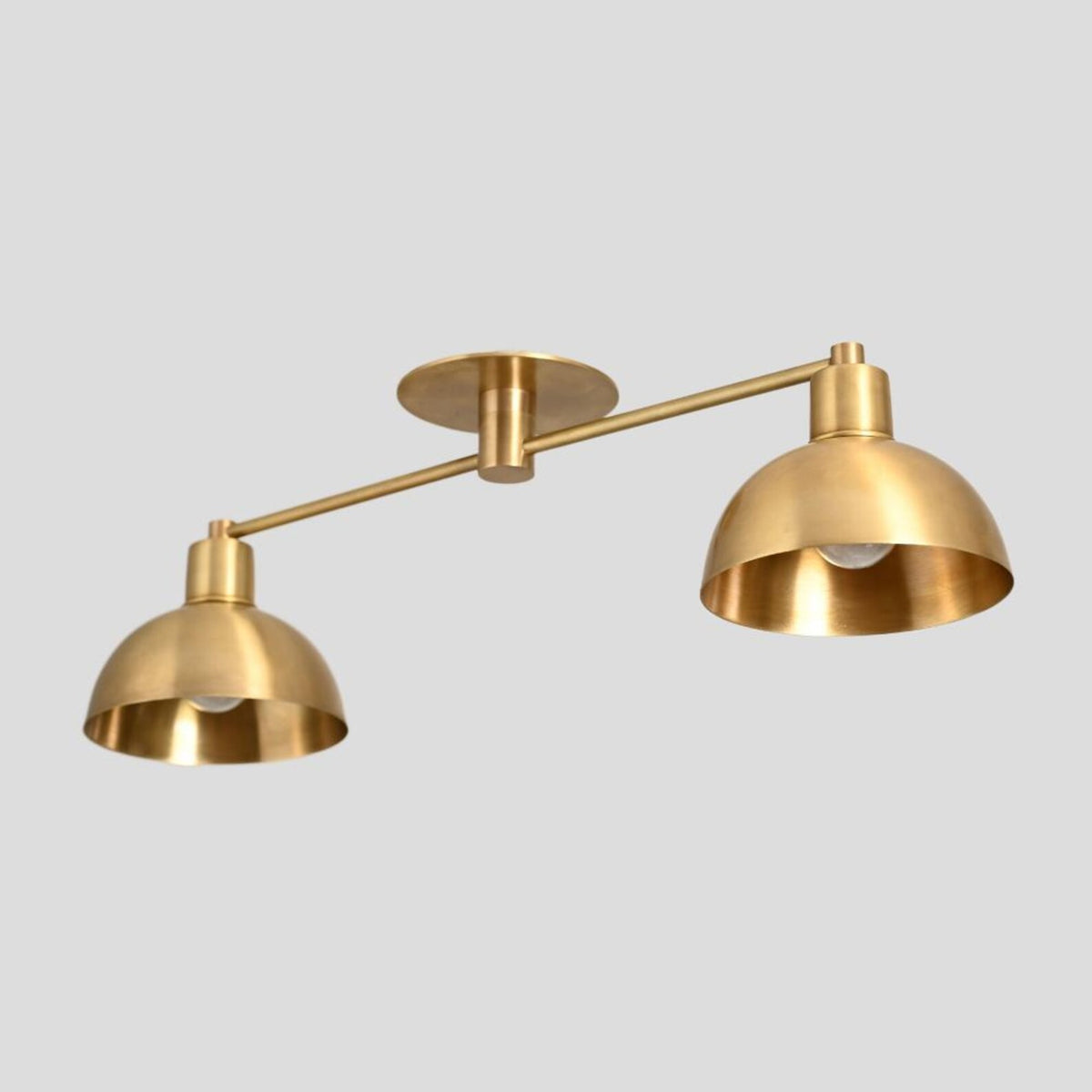 Modern brass dual dome ceiling lamp with lacquer-coated surface.