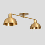 Industrial-style brass double dome ceiling light for contemporary interiors.