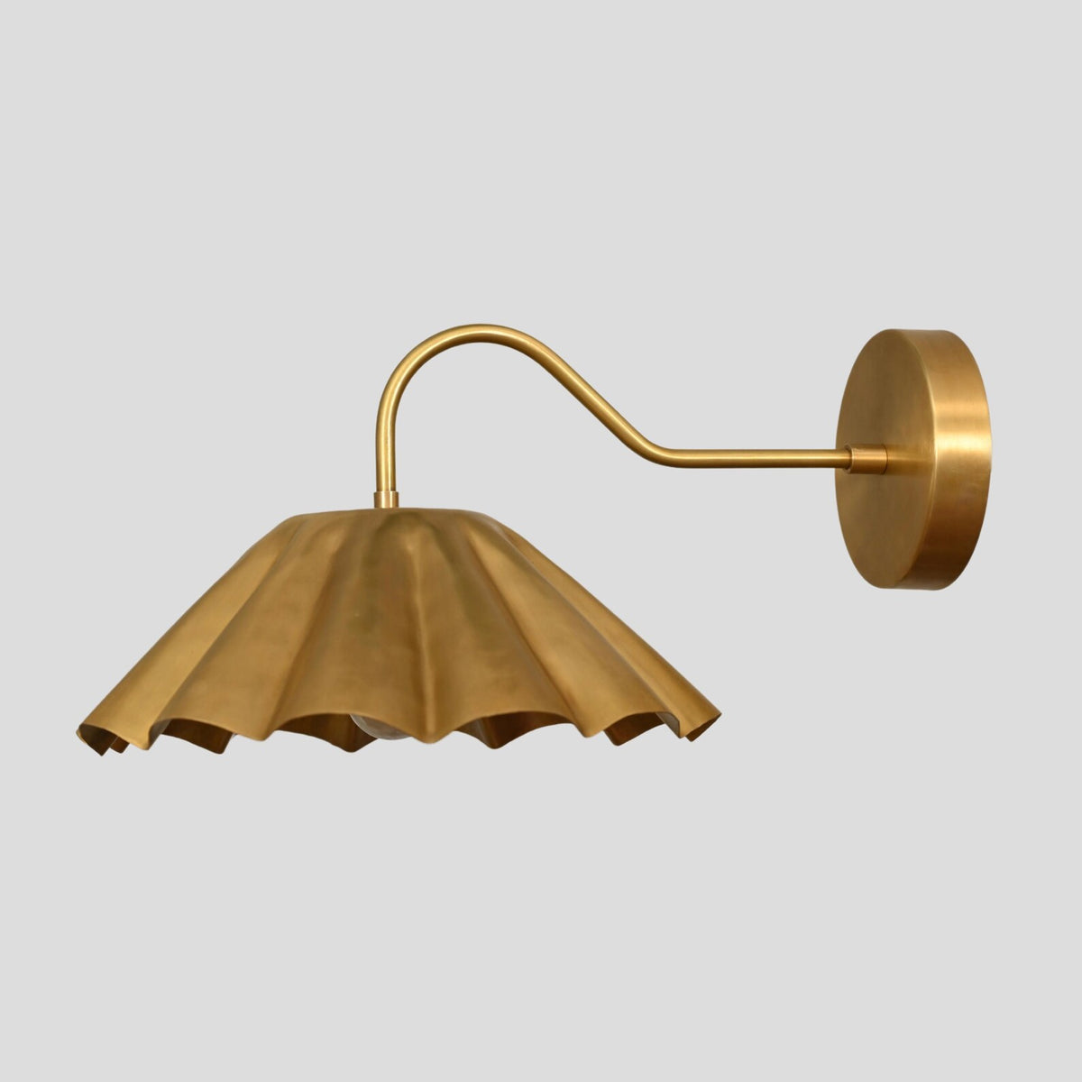 Golden pleated brass wall sconce front angle showing detailed shade and solid brass craftsmanship.