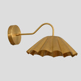 Brass pleated wall light with round backplate and golden finish – artisan handcrafted sconce.