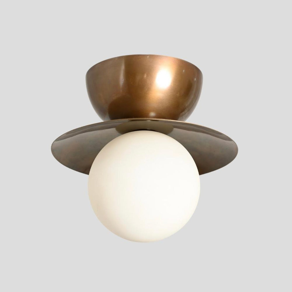 Front angle of brass double bowl ceiling light featuring brass shade and opal glass globe – artisanal flush mount design.