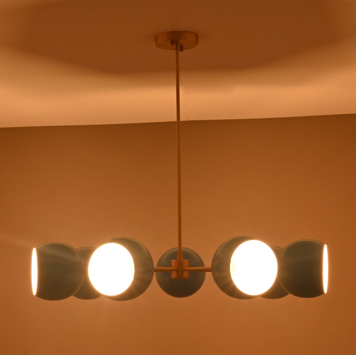 Front installed view of 7 bowl blue glass chandelier handcrafted in solid brass