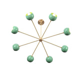 Angled top view of 7 bowl green sputnik chandelier in brushed brass with sculptural modern design