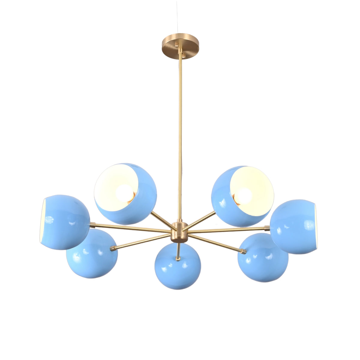 Angled view of modern 7 bowl brass chandelier with blue glass shades in mid century design