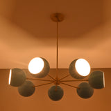 Mid century style 7 bowl brass chandelier creating cozy warm ambience in modern interior