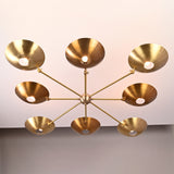Bottom view of 8-light brass disc chandelier with radiating arms and circular brass shades.