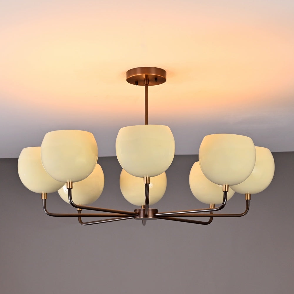Straight-on e-commerce angle showing 8-light brass chandelier with modern bowl shades and sleek metal arms.