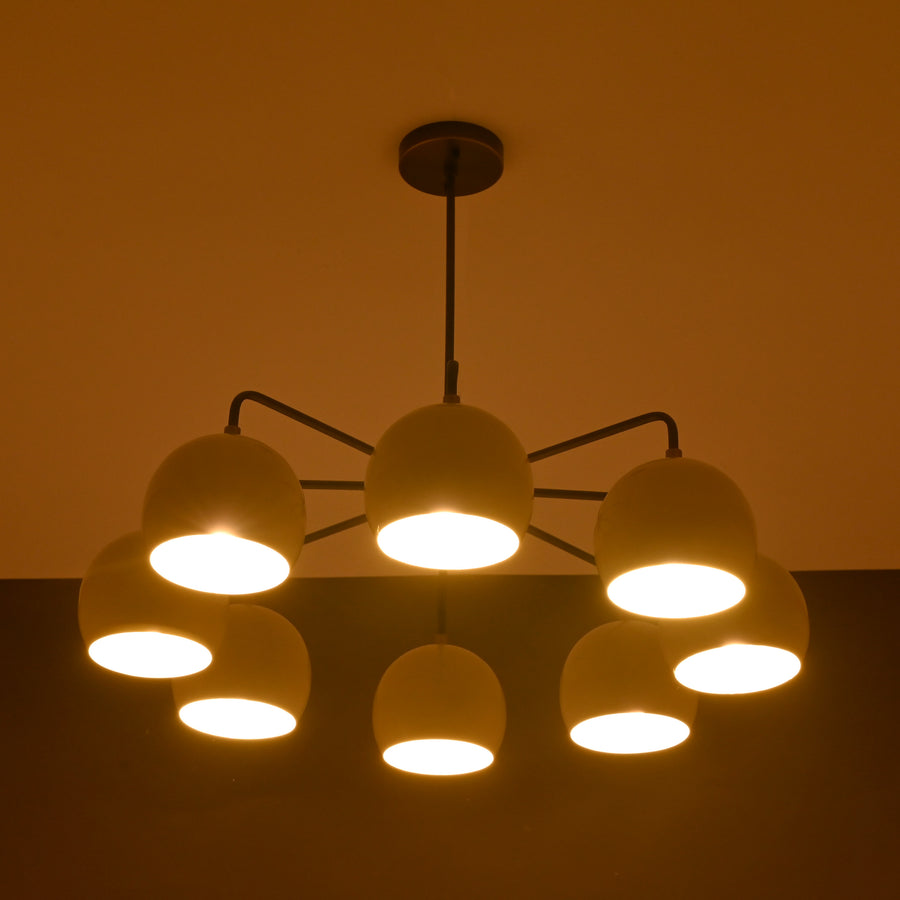 Front view of handcrafted 8-light brass chandelier with ivory bowl shades and bronze finish by Brass Leaf Studio.
