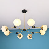 Front view of an 8-light brass globe linear sputnik chandelier with opal glass shades and black accents, suspended from the ceiling in a modern interior.