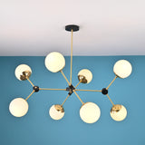 Top-down view of an 8-light brass sputnik chandelier displaying symmetrical arm layout and opal glass globe shades.