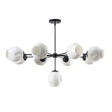 9-light modern brass chandelier with sculpted white shades and black frame by Brass Leaf Studio