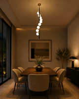 9-light opal globe pendant chandelier with slim black vertical rod and brass-tone ceiling canopy on clean background