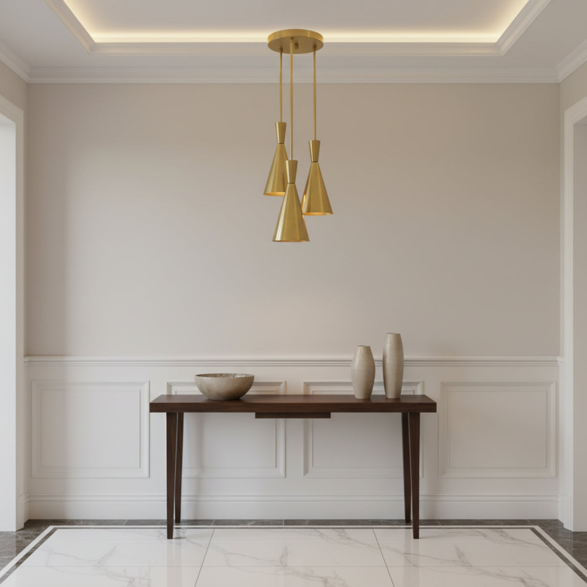 Adelaide 3 light brass-tone cluster chandelier shown from the front with elongated cone shades arranged at staggered heights.