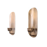 Side perspective of the Alden handcrafted brass wall candle holder highlighting the curved candle arm and elongated oval backplate.