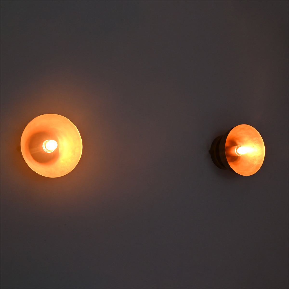 Warmly lit pair of Alden Modern Dome Wall Sconces displaying soft ambient illumination and clean modern design.