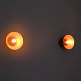 Warmly lit pair of Alden Modern Dome Wall Sconces displaying soft ambient illumination and clean modern design.
