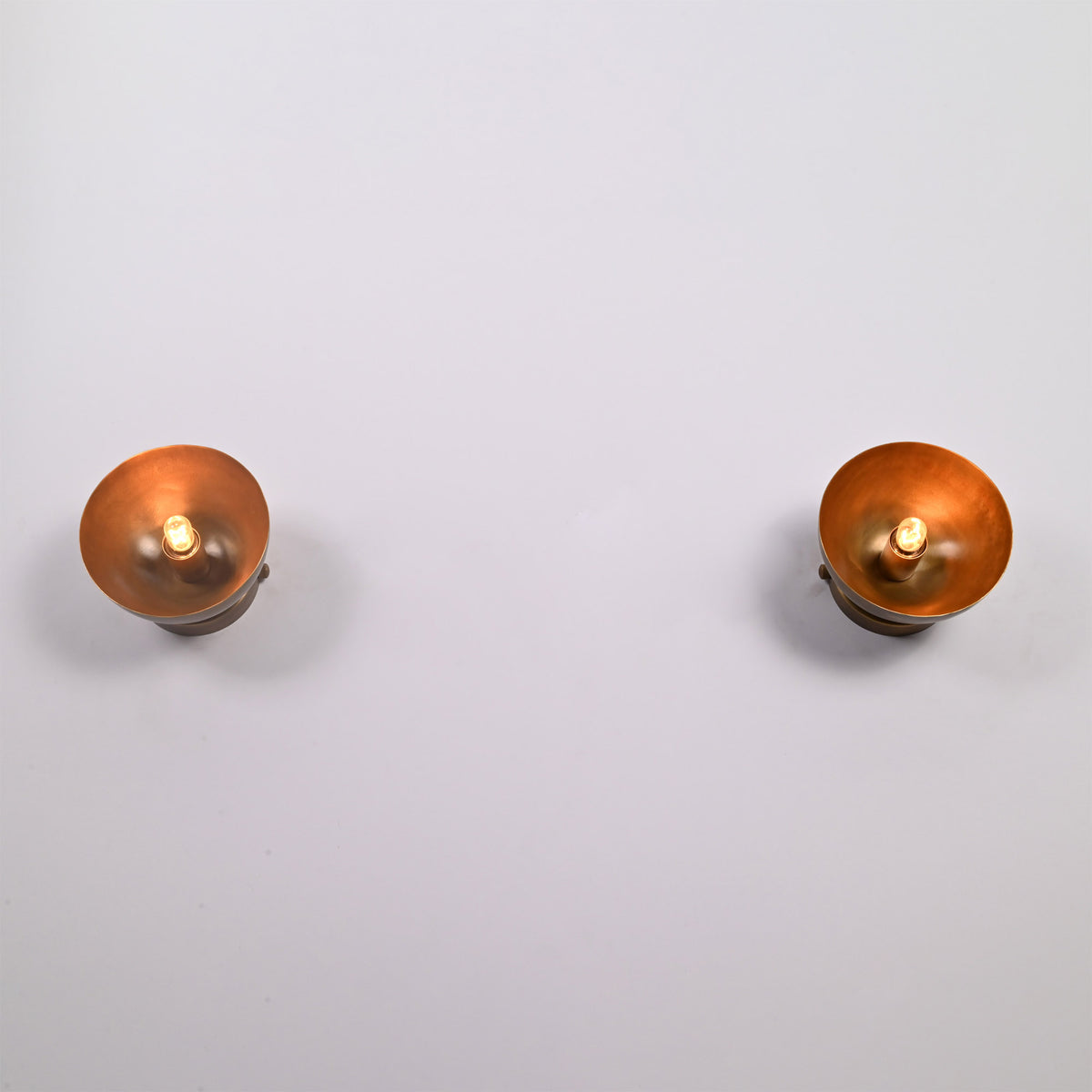 Pair of Alden Modern Dome Wall Sconces with exposed bulbs, showcasing handcrafted dome shades in a symmetrical front-facing arrangement.