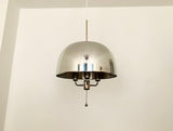 Full view of the Alexandria polished silver dome pendant featuring a smooth reflective metal shade, elegant vertical suspension, exposed light holders, and minimalist retro-modern design.