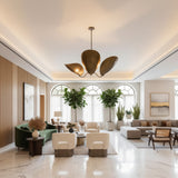 Amalfi 3 light aged brass chandelier shown from the front featuring three sculptural curved leaf-inspired metal shades.