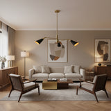 Antwerp 3 light brass and black cone chandelier shown from the front with warm illuminated shades.