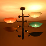 Arcadia Multi Bowl Chandelier glowing warmly in low light with colorful upward-facing bowl shades.