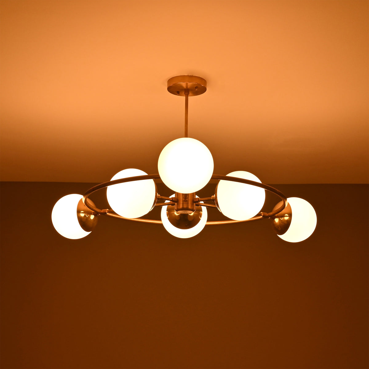 Side view of Aria Orbit Globe Chandelier with six illuminated globes and compact circular ceiling light profile.