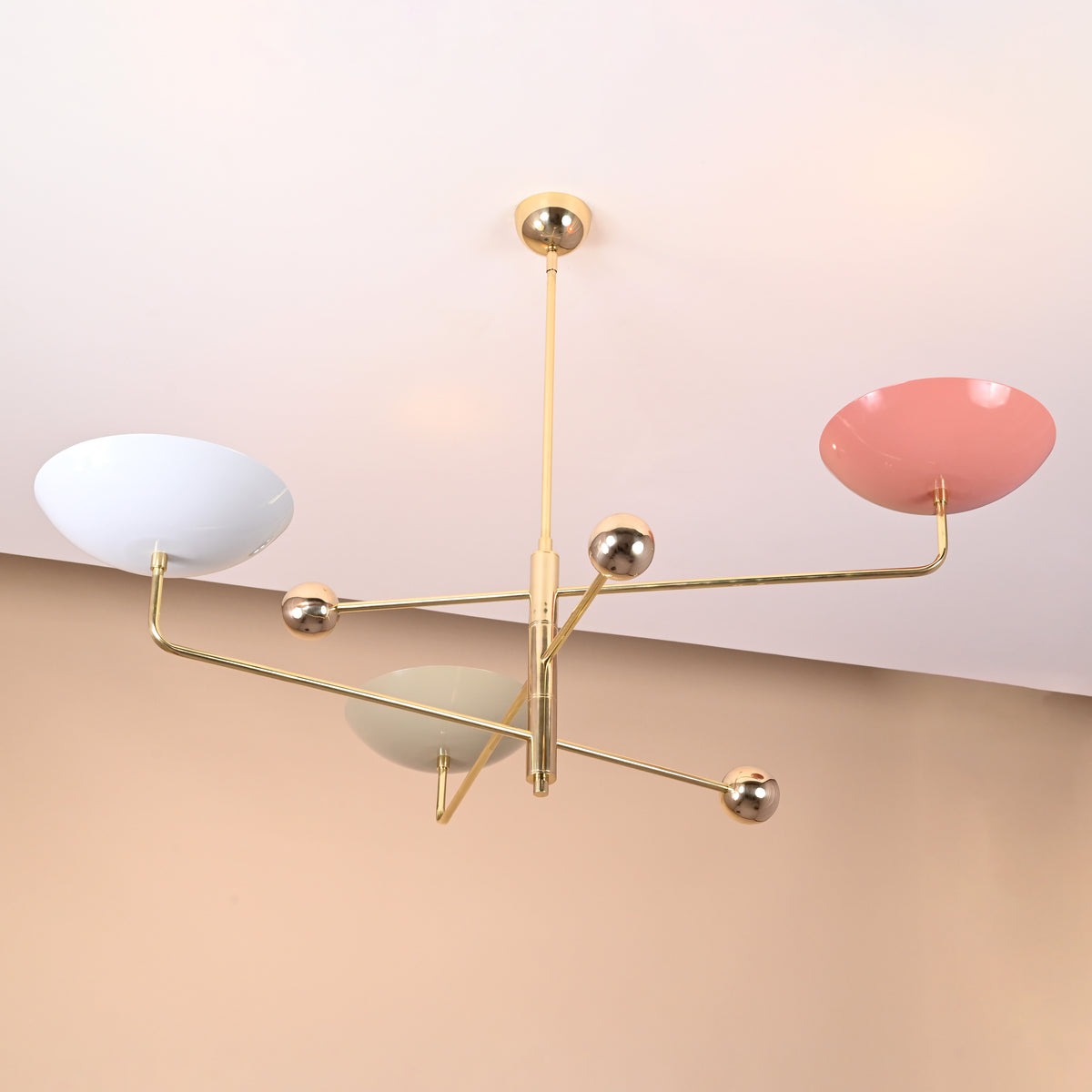 Contemporary handmade brass chandelier with colorful painted bowl shades, highlighting creative modern ceiling light design.