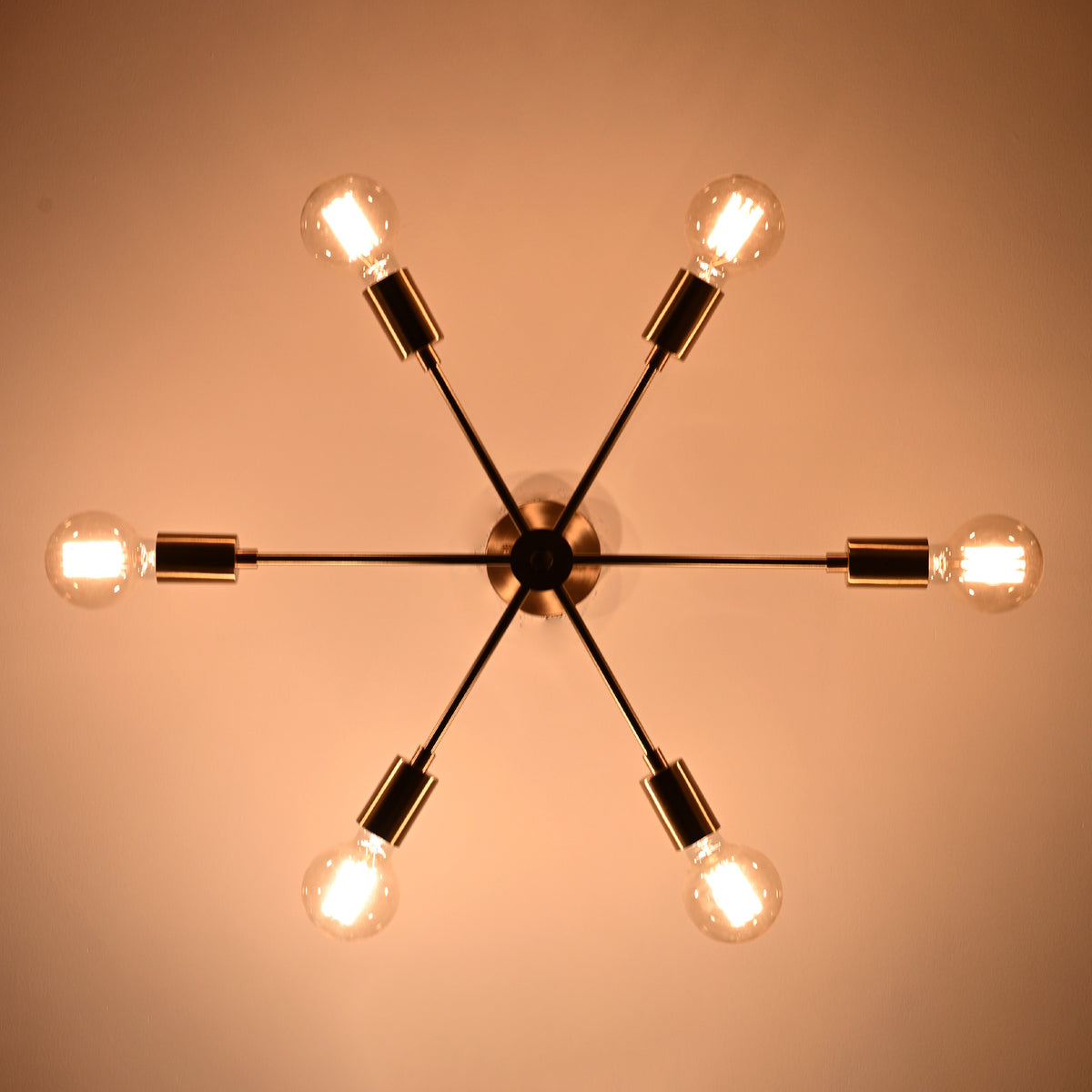 Bottom view of Athens Sputnik six-light ceiling fixture with glowing bulbs and symmetrical starburst arrangement.