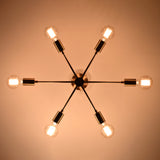 Bottom view of Athens Sputnik six-light ceiling fixture with glowing bulbs and symmetrical starburst arrangement.