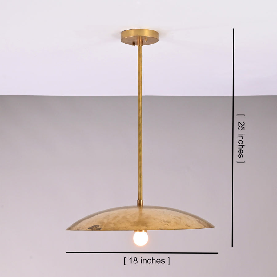 Aurelia Petite Saucer Pendant Light installed above a kitchen island in a warm modern interior.