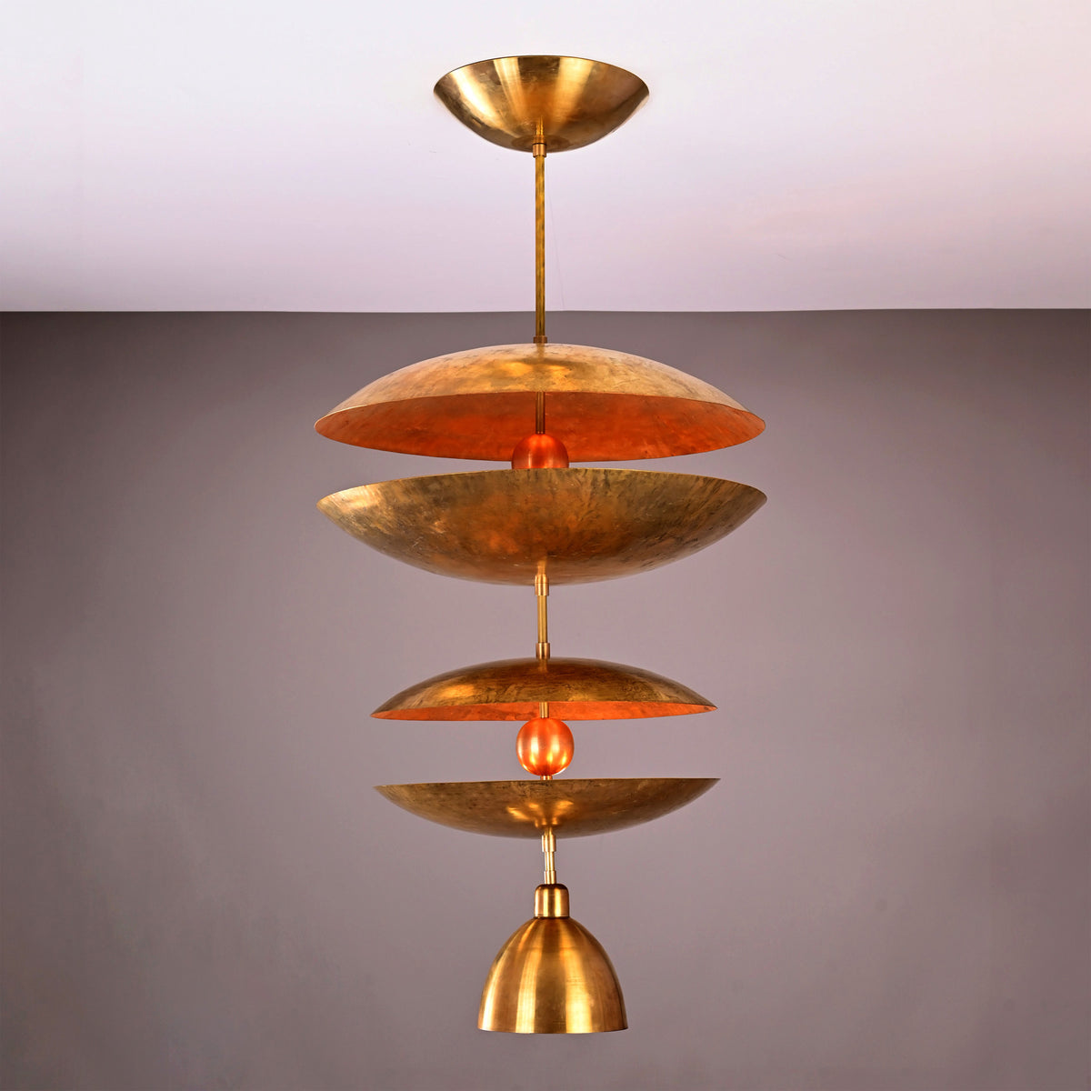 Aurelia Tiered Disc Chandelier shown on plain background with sculptural layered design and ceiling canopy.