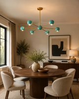 Aurora 6 light turquoise globe Sputnik chandelier installed above a round dining table in a warm modern dining room