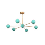Front view of Aurora 6 light Mid-Century Modern chandelier featuring turquoise globe shades and brass arms