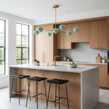 Perspective view of Aurora 6 light Sputnik chandelier featuring sculptural turquoise globe shades and brass details