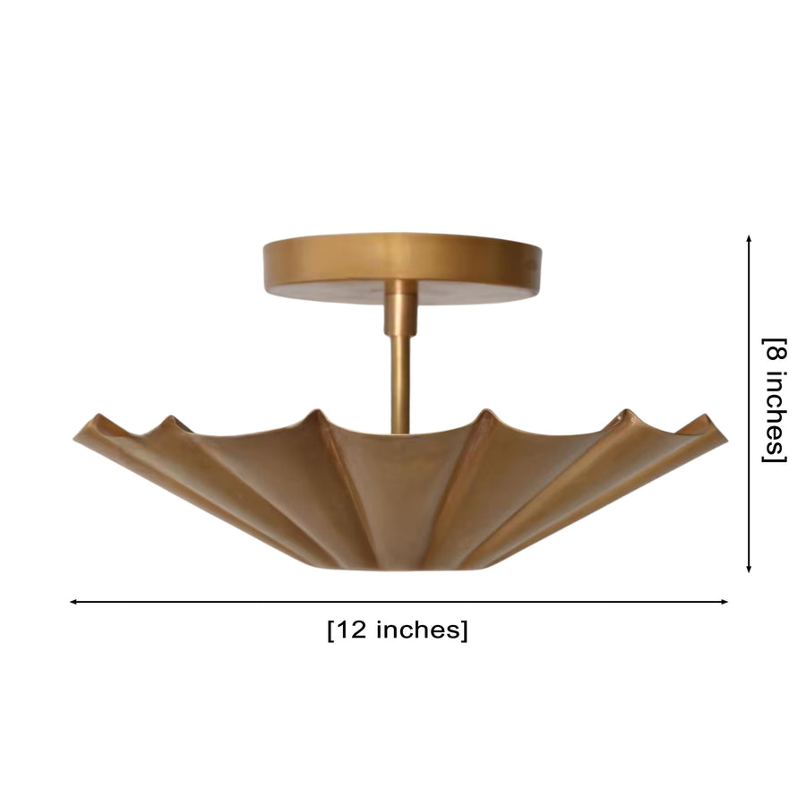 Aurora fluted scallop flush mount ceiling light installed in a modern living room, providing warm ambient illumination with an elegant handcrafted brass finish.