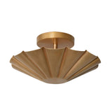 Perspective view of the Aurora modern flush mount ceiling light featuring a handcrafted fluted brass shade with a refined contemporary silhouette.