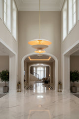 Aurora 24 inch layered petal pendant chandelier illuminated with warm golden ambient light.