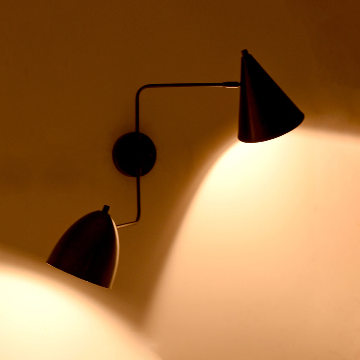 Night view of the Aurora modern dual shade wall sconce featuring warm ambient illumination and a minimalist matte black dual-shade contemporary design.