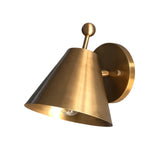 Side perspective of the Aurora satin brass tapered wall sconce highlighting the cone shade, round backplate, and minimalist design.