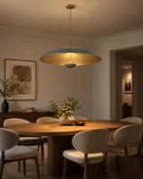 Aurora 3 light patina dome pendant chandelier installed above a dining table in a warm modern interior.