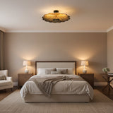 Aurora sculpted floral flush mount illuminated with warm light highlighting the textured aged brass petals.