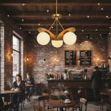 Aurora sculptural brass petal chandelier with three illuminated opal glass globes, angled product view
