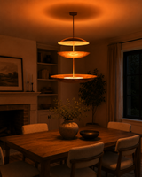 Aurora Triple Saucer Chandelier installed above a dining table in a warm modern interior.