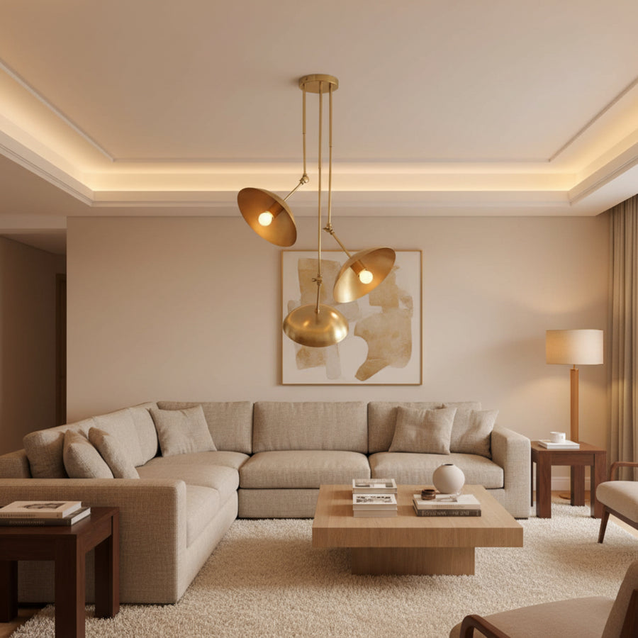 Avignon 3 light brass tone chandelier featuring asymmetric circular disc shades with illuminated bulbs.