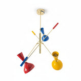 Bangkok 6 light Mid-Century Modern chandelier shown from an alternate angle highlighting colorful metal shades and sculptural brass-tone arms.