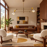 Bath 4 light sculptural balance chandelier shown from the front with dark bronze arms and white and yellow metal shades.