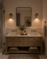 Pair of Milan adjustable antique brass cylinder wall sconces installed beside a bathroom vanity mirror, providing elegant task and accent lighting.