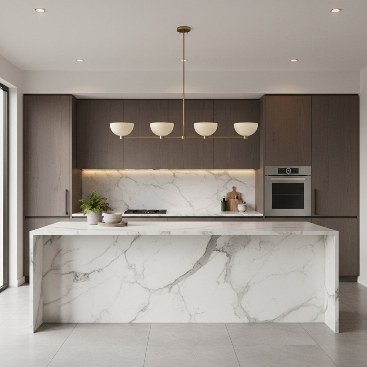 Bern 4 light metal bowl linear chandelier shown in a full front view with four ivory shades and a brass frame.