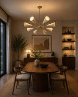 Bern 8 light ivory and brass sculptural chandelier displayed above a warm modern wood dining table.