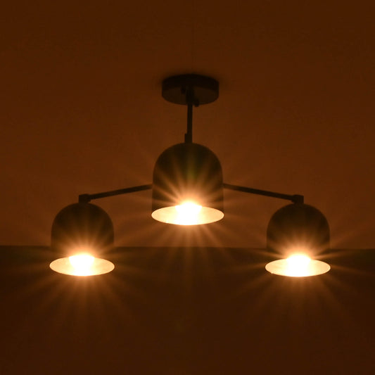 Warm glowing 3-light black brass chandelier with dome-shaped shades, creating a soft ambient effect in a dark room.